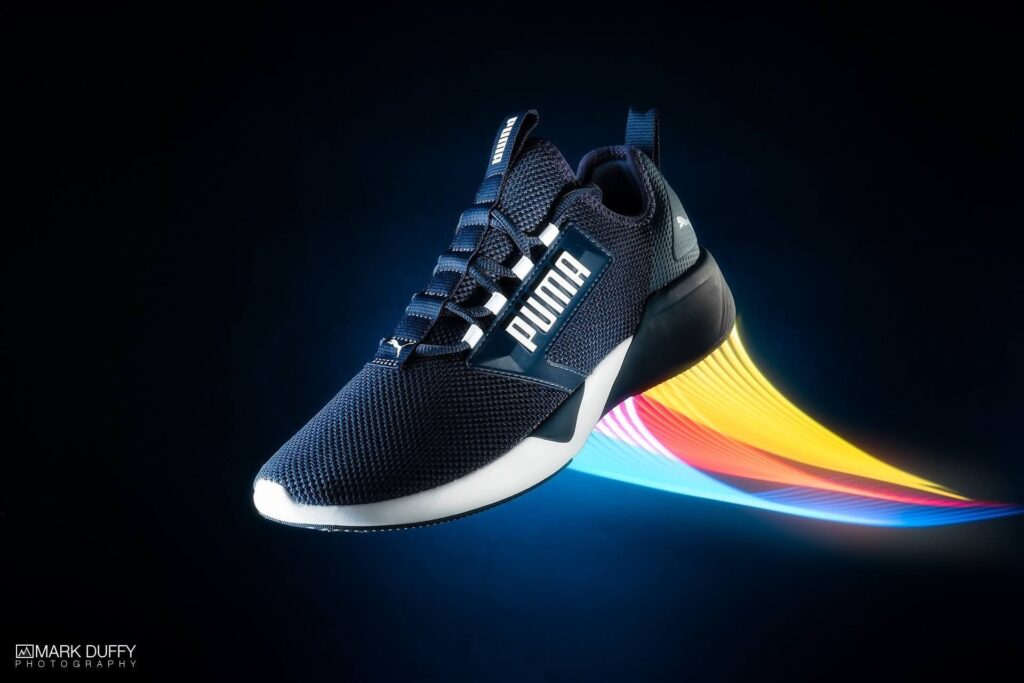 Product photography of Puma trainer light painted with KYU-6 RGB light wrap